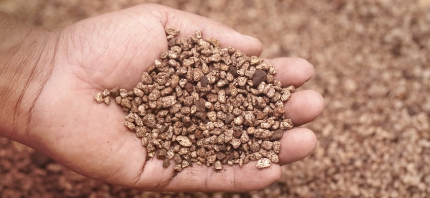 Close up shot of hands scooping gravel.